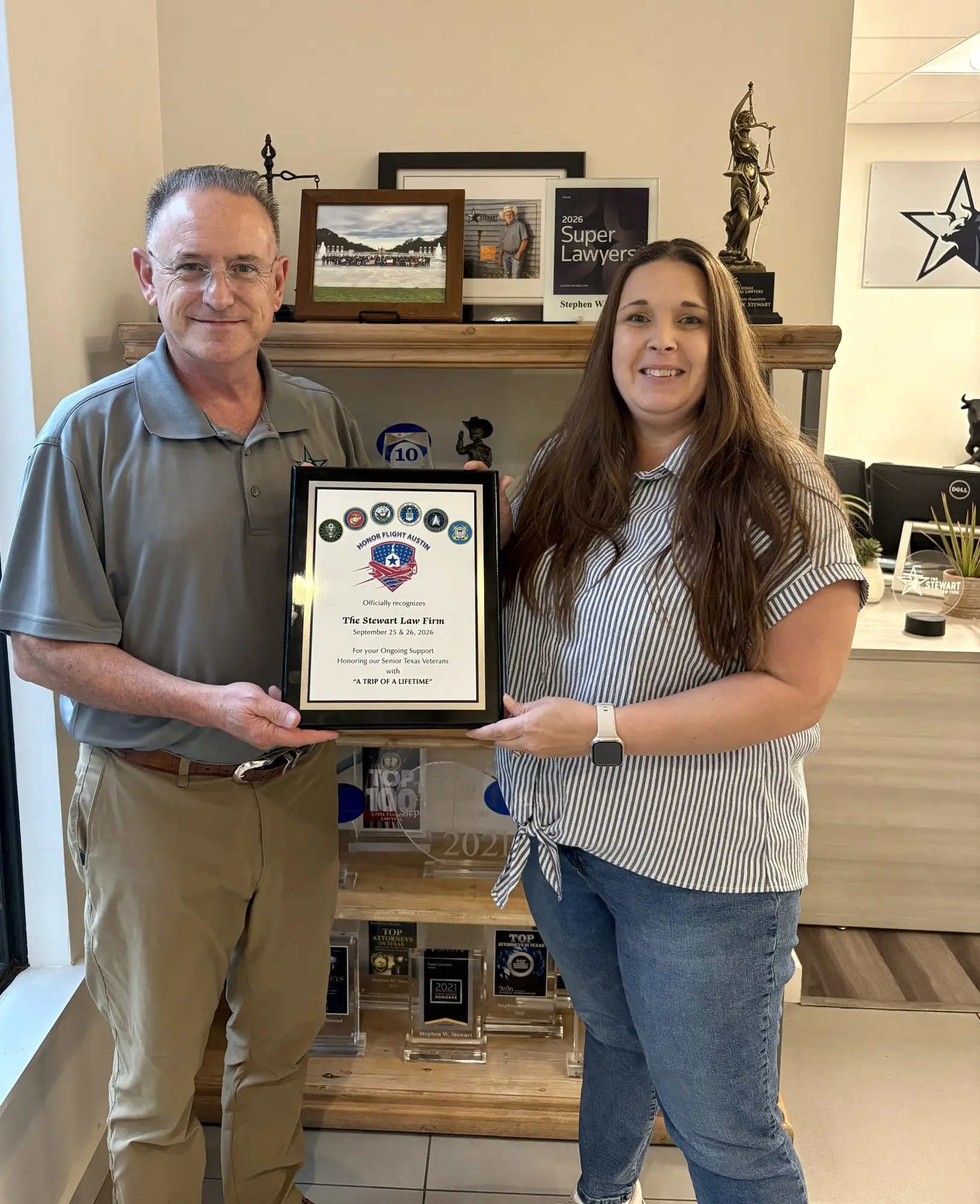 Stephen Stewart and Carrie holding the Honor Flight Austin appreciation plaque